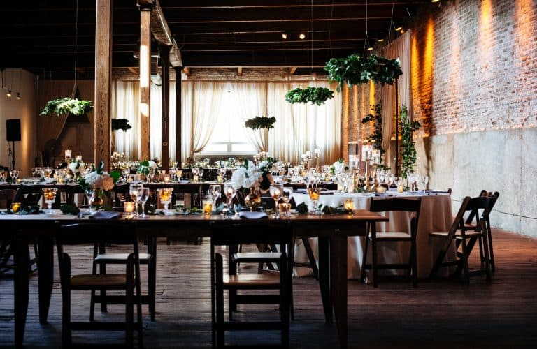 dinner tables setup and decorated in an industrial space