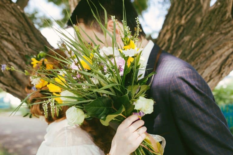 wedding kiss on a spring/ summer day / newlyweds