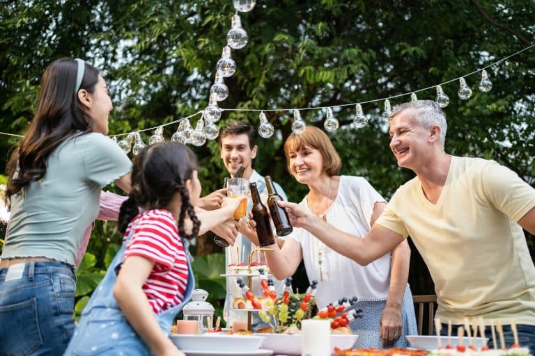 Multi-ethnic family celebrate weekend reunion gathered together, enjoy party outdoors in the garden.