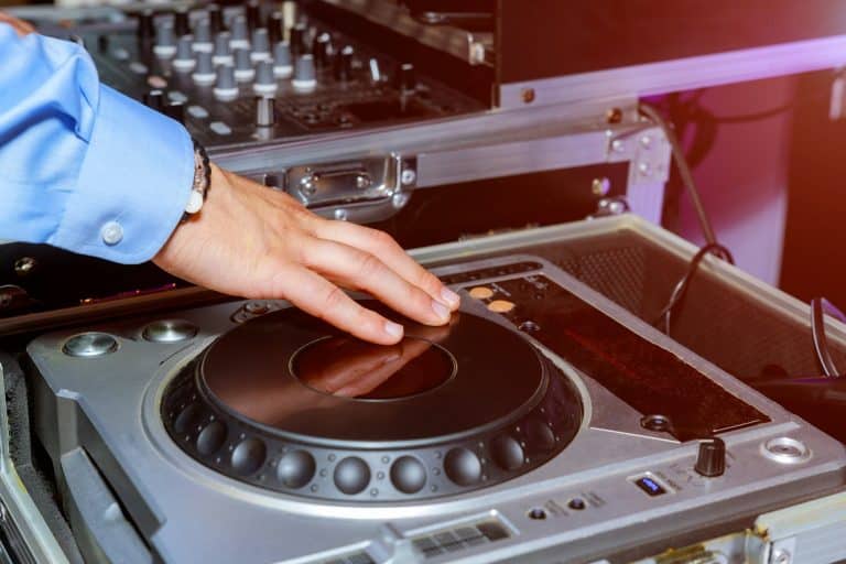 DJ hands and remote and mixer DJ for music